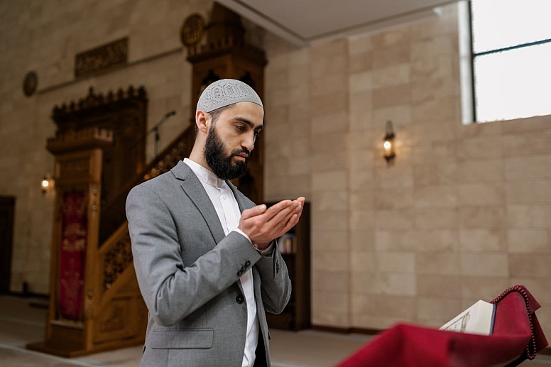 muslim man making dua in a masjid